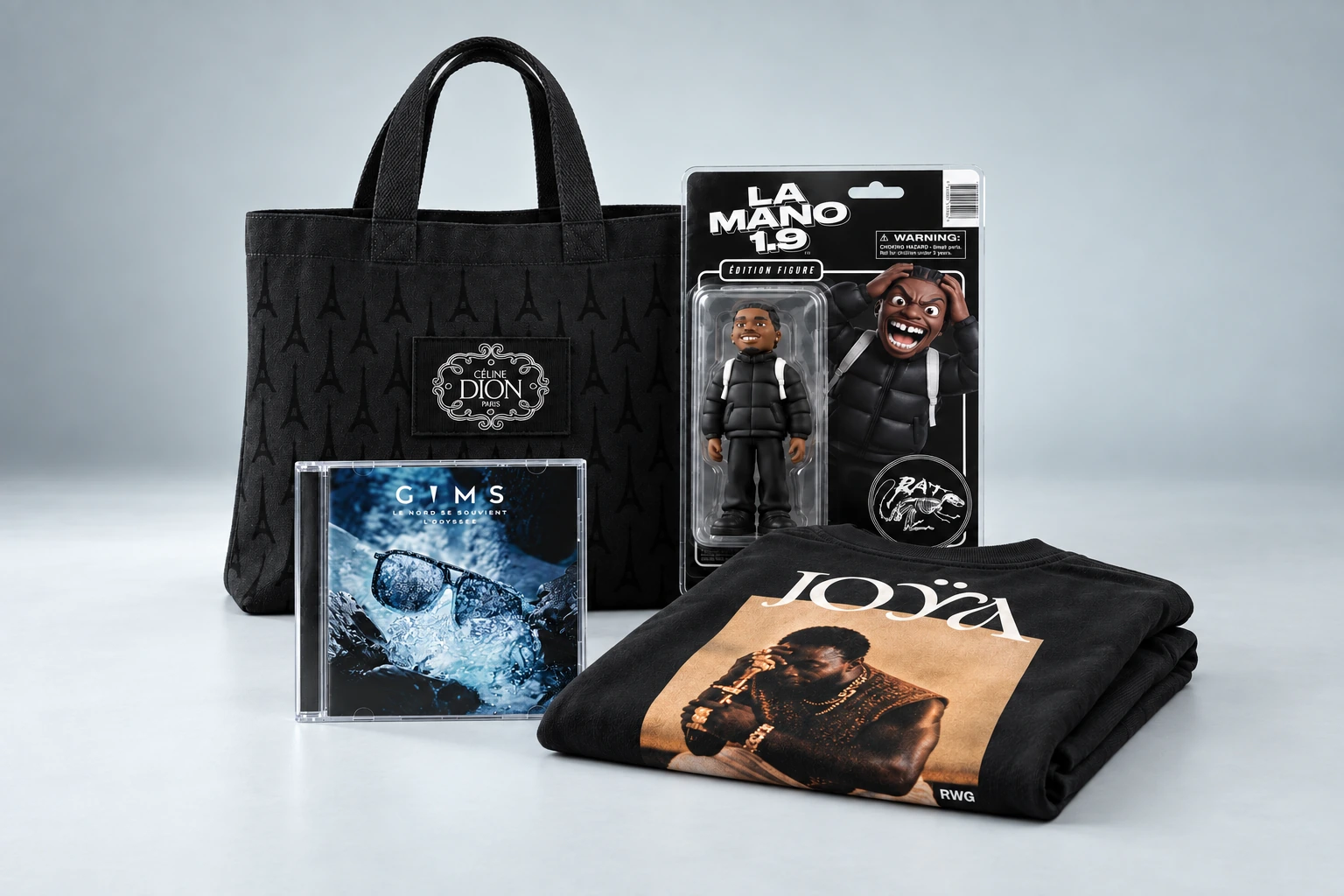 Composition de studio : sac Céline Dion, t-shirt Tayc JOŸA plié avec son portrait au dos, CD de Gims et figurine La Mano 1.9